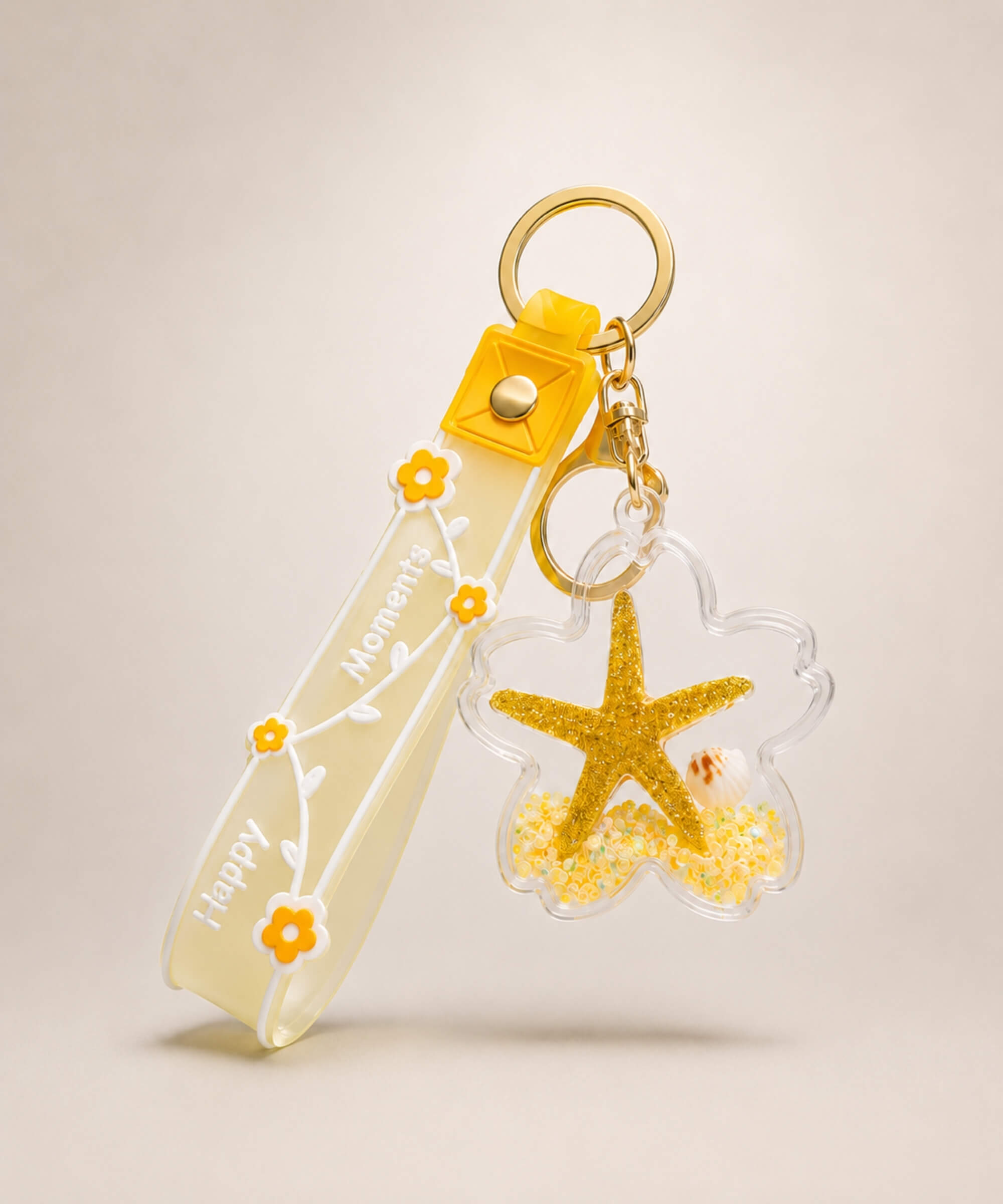 Yellow starfish liquid keychain with yellow glitter, shell detail, floral strap and gold hardware